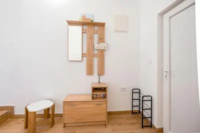 a room with a table and a chair and a shelf at Harmony Point in Bar