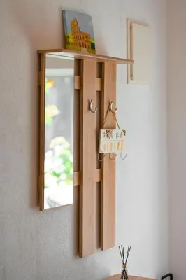 a mirror hanging on a wall with a shelf at Harmony Point in Bar
