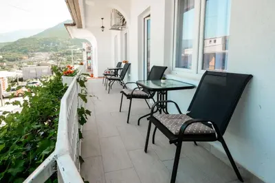a balcony with chairs and a table and windows at Harmony Point in Bar