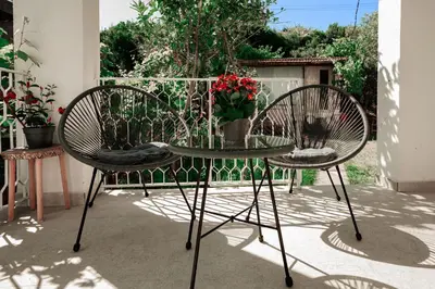 two chairs and a glass table on a patio at Harmony Point in Bar