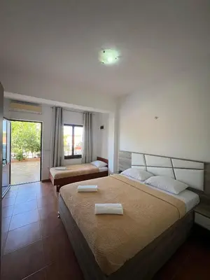 a bedroom with two beds with towels on them at Enes Apartments in Ulcinj
