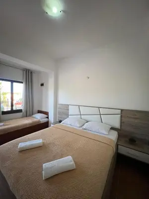 a bedroom with two white pillows on a bed at Enes Apartments in Ulcinj