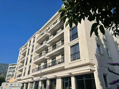 a white building with balconies on the side of it at Apartment ViSi 19 in Budva