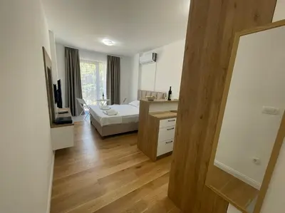 a room with a bedroom with a bed and a desk at Apartment ViSi 19 in Budva