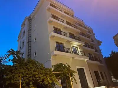 a tall white building with balconies on it at Apartment ViSi 19 in Budva