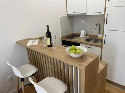 a small kitchen with a bowl of fruit on a counter at Apartment ViSi 19 in Budva