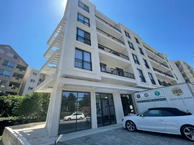 a white car parked in front of a building at Apartment ViSi 19 in Budva