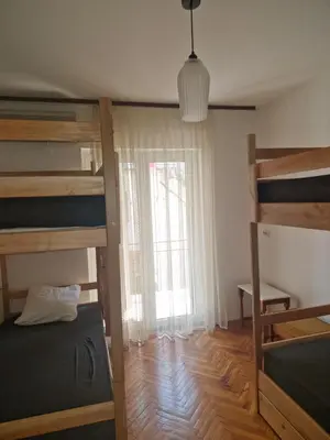 a bedroom with two bunk beds and a window at Golden Bay Apartment in Kotor