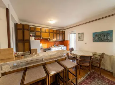 a kitchen with a counter and a table and chairs at Golden Bay Apartment in Kotor