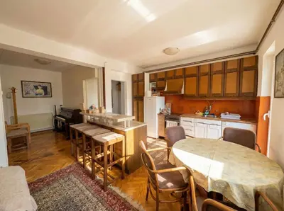 a kitchen and dining room with a table and chairs at Golden Bay Apartment in Kotor