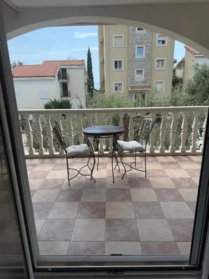 a patio with a table and chairs on a balcony at Studio Sea View Steps to Przno beach w Parking Villa Olive in Pržno