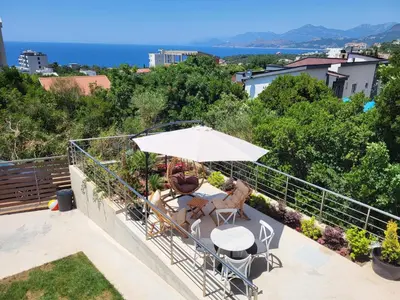 a patio with an umbrella and a table and chairs at MiLA - Hladna Uvala in Utjeha