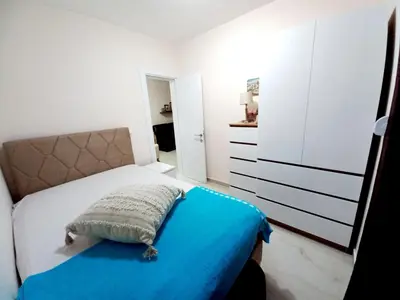 a bedroom with a bed with a blue blanket at MiLA - Hladna Uvala in Utjeha
