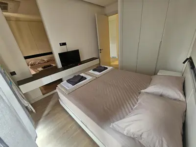 a small bedroom with two beds and a mirror at Montebay Apartment in Becici