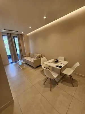 a living room with a table and chairs and a couch at Montebay Apartment in Becici