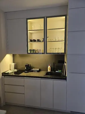 a kitchen with white cabinets and a sink at Montebay Apartment in Becici
