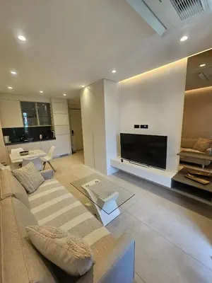 a living room with a couch and a flat screen tv at Montebay Apartment in Becici