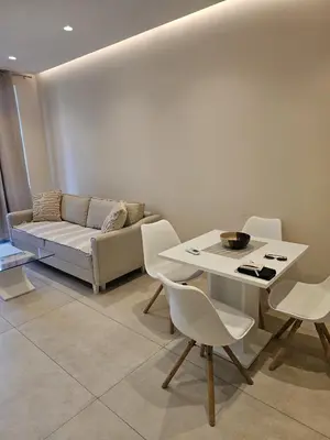 a living room with a couch and a table and chairs at Montebay Apartment in Becici