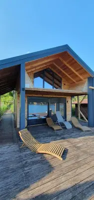 a house with a deck with chairs on it at CabinAtRiver Ada Bojana in Ulcinj