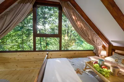 a room with a bed with a window and a tray of fruit at Mountain harmony Lovćen in Cetinje