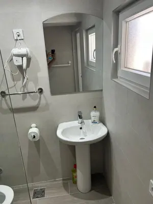 a bathroom with a sink and a mirror at Apartmani Filipovic in Podgorica
