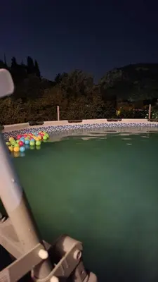 a view of a pool of water at night at Apartman Buljarica-Bačvice 1 in Petrovac na Moru