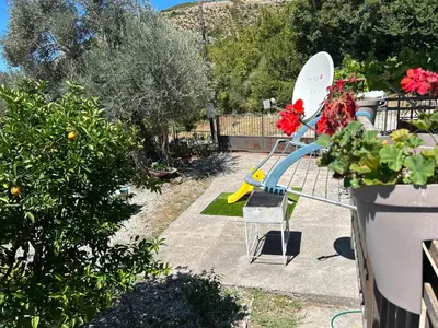 a slide in a garden with flowers and plants at Apartman Buljarica-Bačvice 1 in Petrovac na Moru