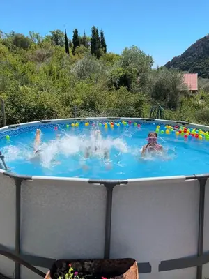 a group of people in a swimming pool at Apartman Buljarica-Bačvice 1 in Petrovac na Moru