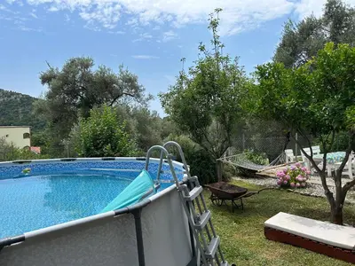 a swimming pool with a slide in a yard at Apartman Buljarica-Bačvice 1 in Petrovac na Moru