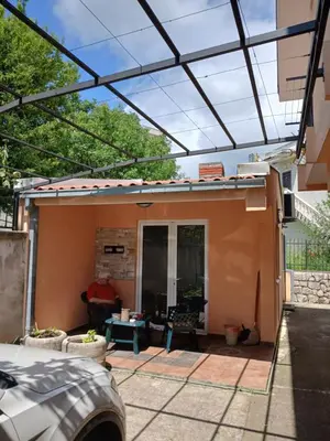 an outside view of a house with a glass roof at Apartmani Bisser in Sutomore