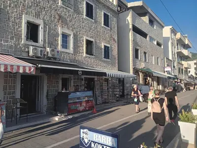 a group of people walking down a street at Apartmani Bisser in Sutomore