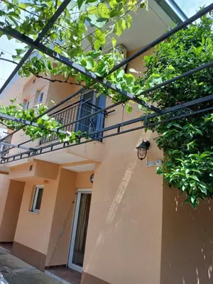 a building with a balcony on the side of it at Apartmani Bisser in Sutomore
