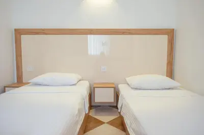 two beds sitting next to each other in a room at Lana Apartments in Ulcinj