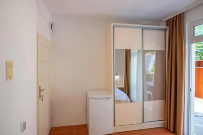 a room with a closet with a glass door at Lana Apartments in Ulcinj