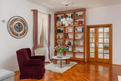 a living room with a vase of flowers on a table at Epoha Apartment in Kotor