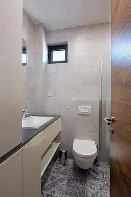 a bathroom with a toilet and a sink at Modern home in the city center in Budva