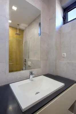 a bathroom with a white sink and a mirror at Modern home in the city center in Budva