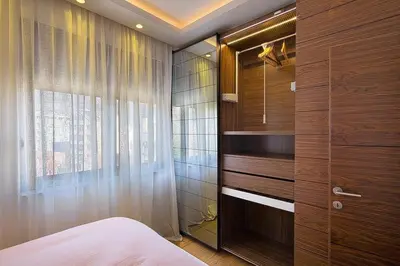 a bedroom with a bed and a large window at Modern home in the city center in Budva