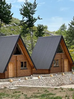 a log cabin with a black roof at Gorska Dolina in Ivanova Korita