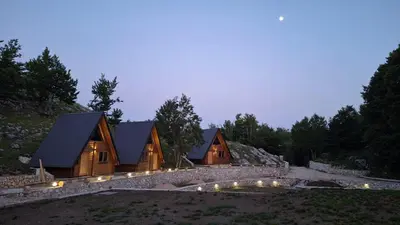 a row of wooden cabins in a forest at night at Gorska Dolina in Ivanova Korita