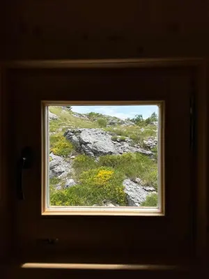 a window in a room with a view of a field at Gorska Dolina in Ivanova Korita
