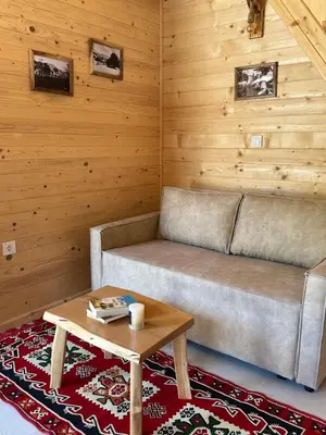 a living room with a couch and a coffee table at Gorska Dolina in Ivanova Korita