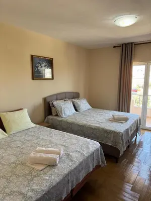 a bedroom with two beds with towels on them at Apartments Family Ibrahimi in Ulcinj
