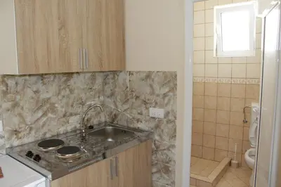 a small kitchen with a sink and a toilet at Apartments Family Ibrahimi in Ulcinj