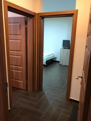 a room with a door and a room with a bedroom at Apartments Family Ibrahimi in Ulcinj