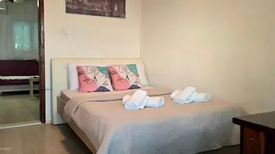 a small bedroom with a bed with towels on it at Alpha Casa in Bar