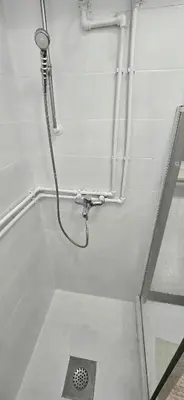 a shower in a bathroom with a drain in the floor at Alpha Casa in Bar