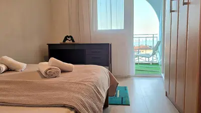 a bedroom with a bed with a view of a balcony at Alpha Casa in Bar