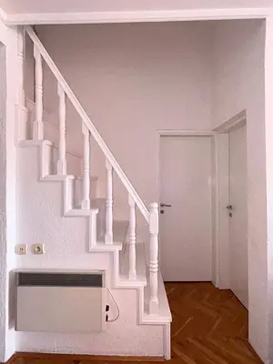 a white staircase in a white room with a door at Sunset Bay Budva in Budva