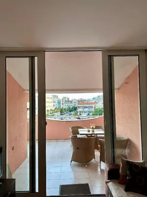 a living room with a view of a table and chairs at Sunset Bay Budva in Budva